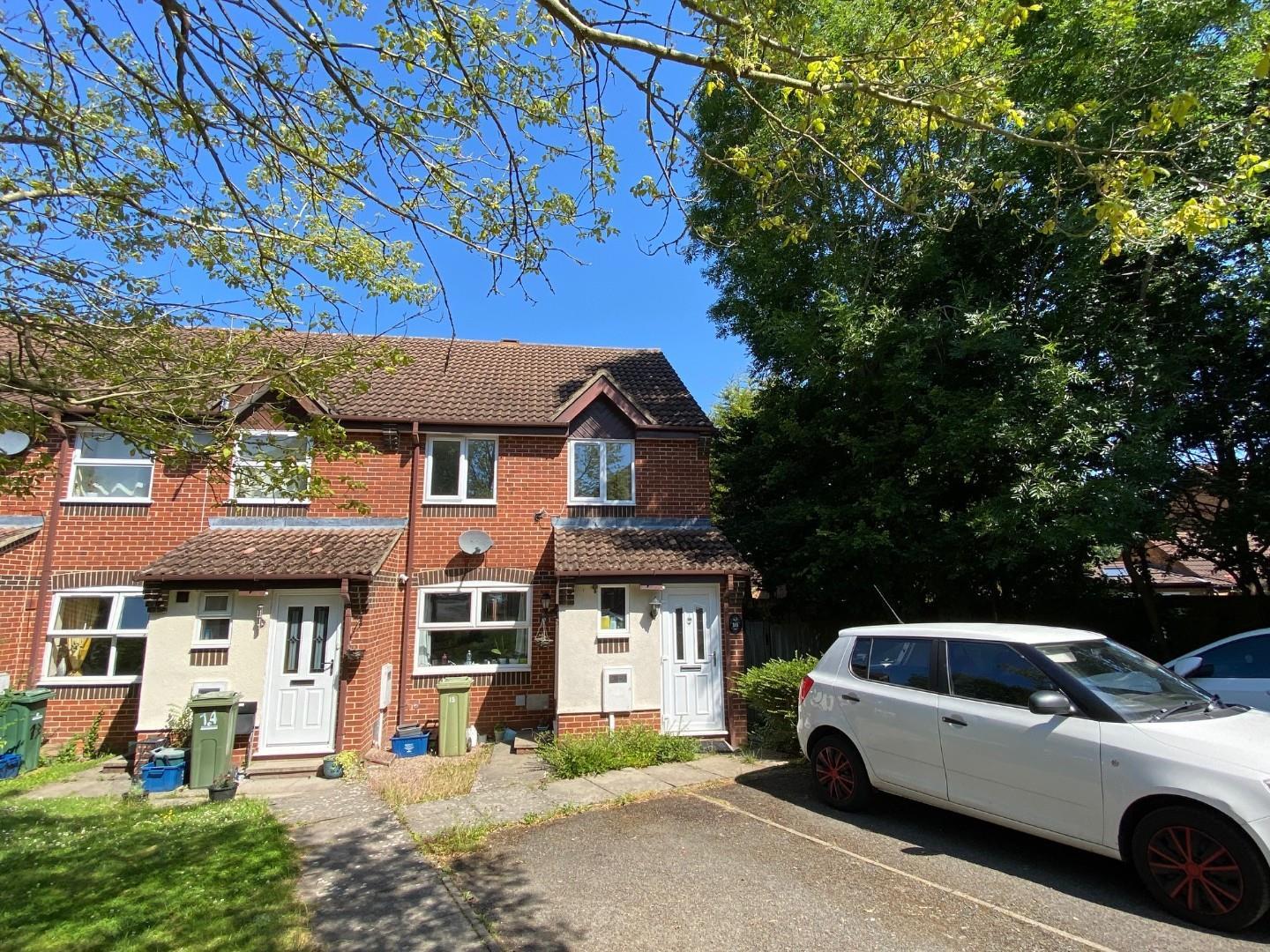 Brick house with white car and trees